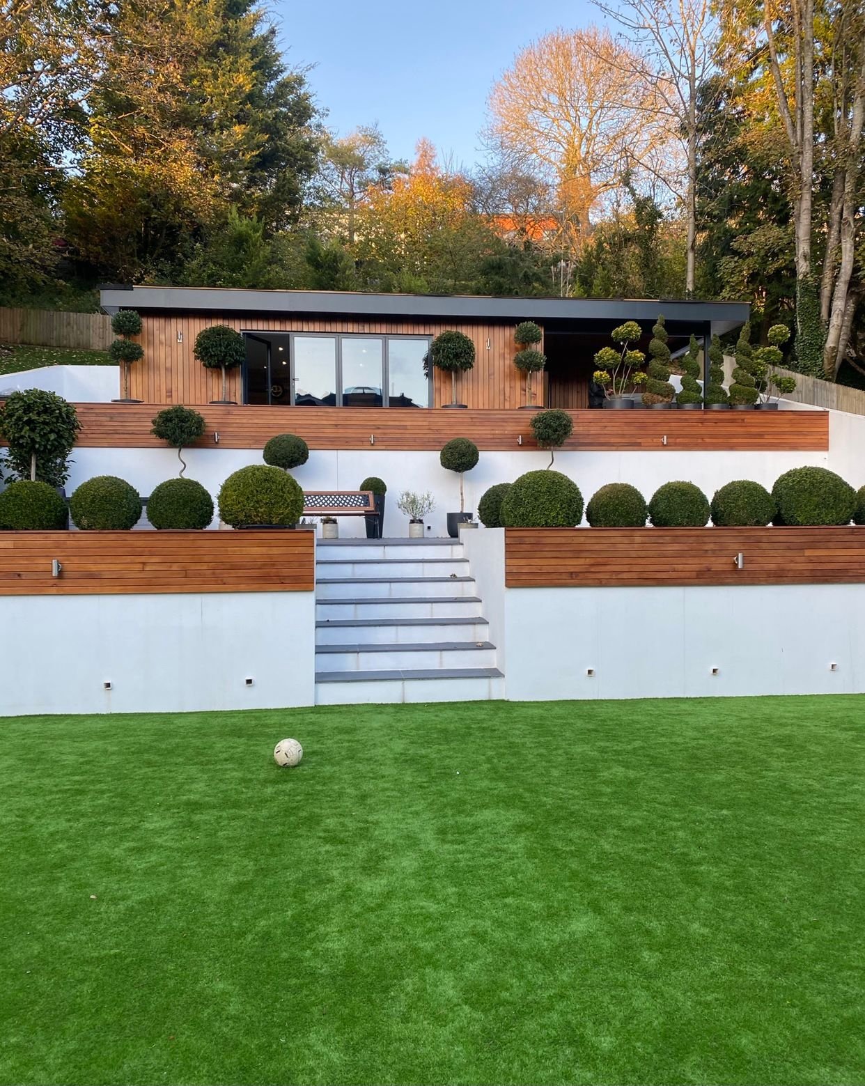 Transformed outdoor space with newly installed cladding on a summer house, enhancing its durability and style.