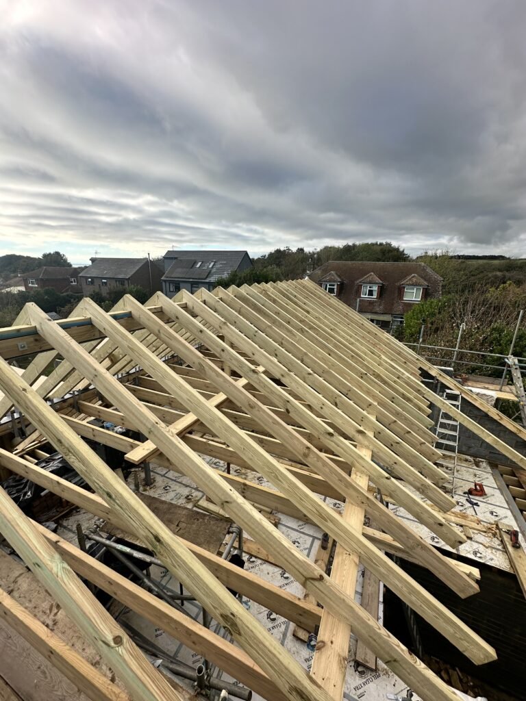 Skilled rafter fitting for hand-cut pitched roof in Peacehaven by Procut Carpentry