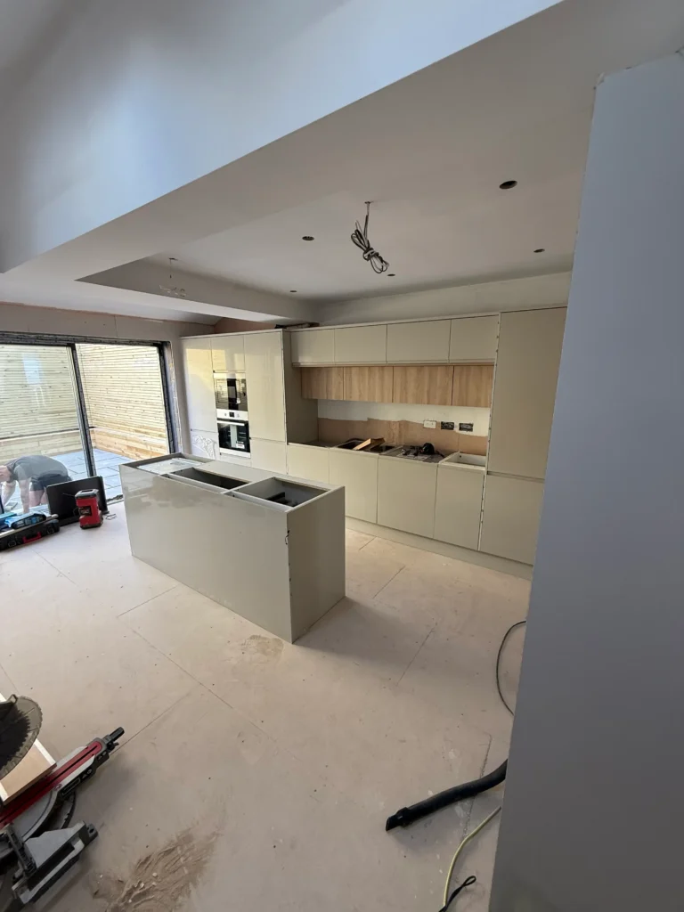 Open plan kitchen design featuring expansive quartz surfaces.