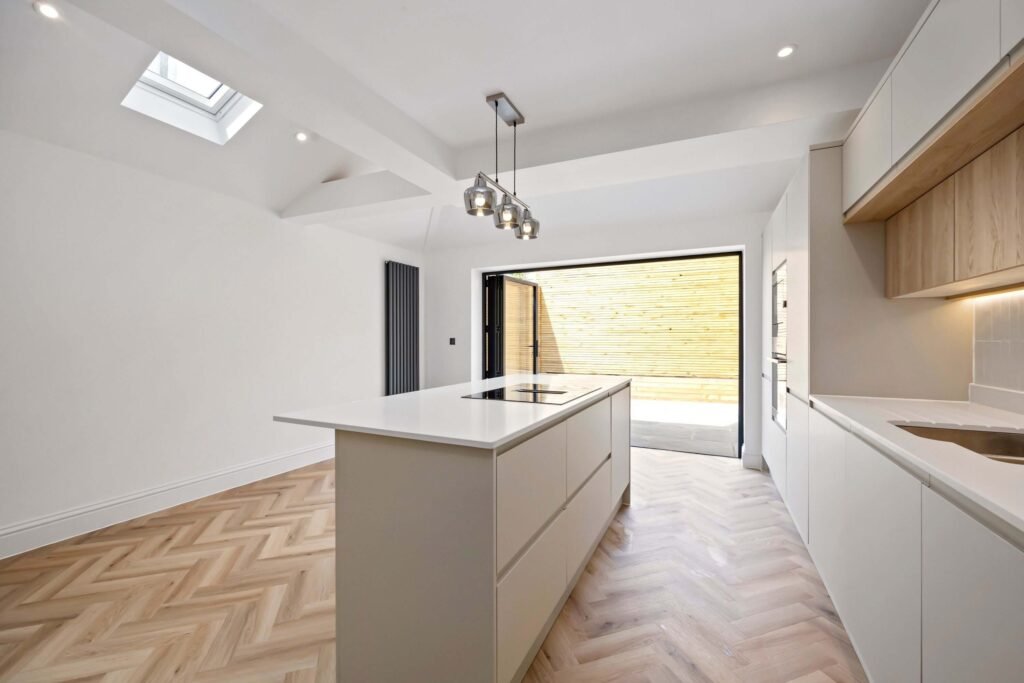 Wide view of completed Howdens kitchen featuring quartz worktops and modern cabinetry