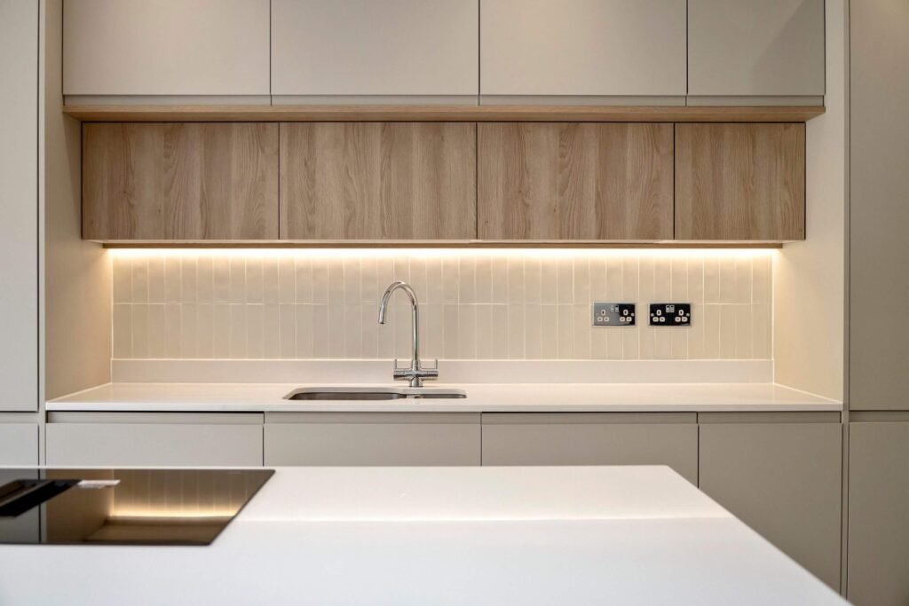 View of kitchen sink counter and drawers with quartz worktop and modern fittings